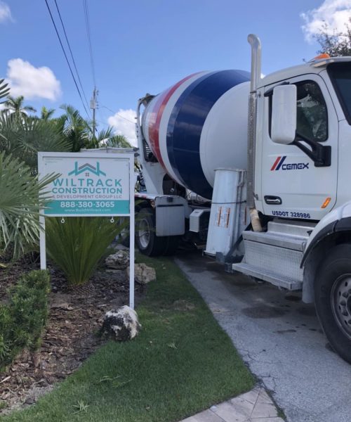 Concrete truck on jobsite wiltrack construction sign